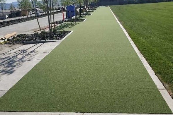 Jacksonville Outdoor tee line consisting of one continuous green synthetic grass strip surrounded by trees